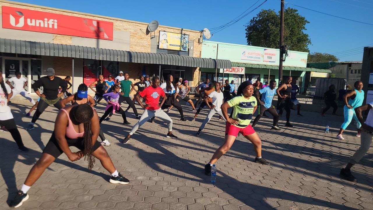 Community aerobics session — participants warming up